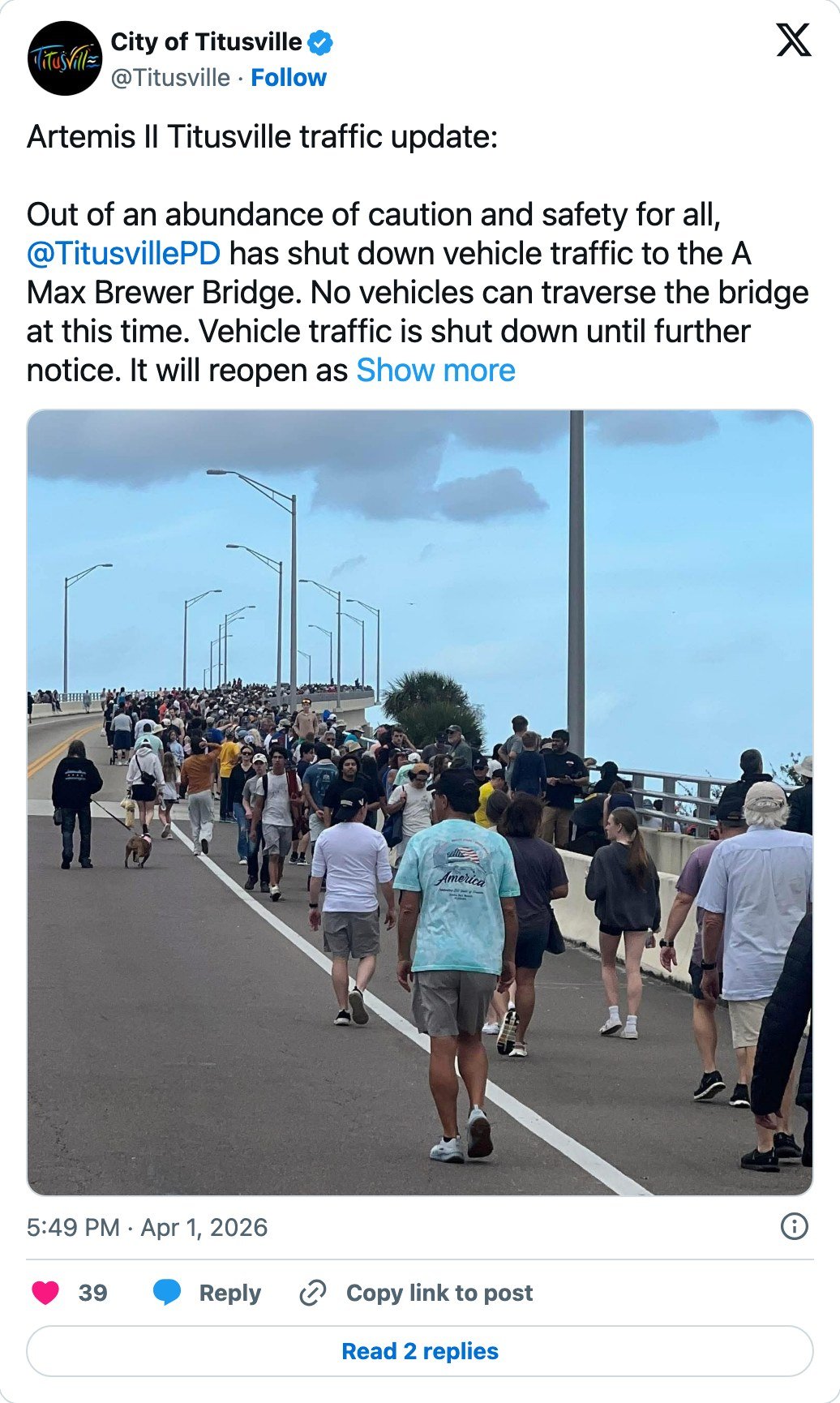 City of Titusville post on X giving an Artemis II traffic update, reporting that Titusville police have shut vehicle traffic on the A Max Brewer Bridge, with a photograph of crowds walking across the closed bridge
